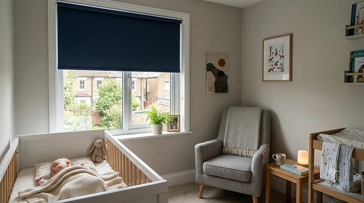 A cosy, darkened nursery room in a British home featuring high-quality blackout blinds on the window to ensure a peaceful sleep for the baby.