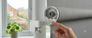 A close-up demonstrating the integrated cordless safety mechanism on a blackout roller blind.