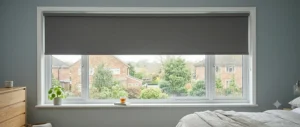 A sleek blackout roller blind fitted neatly inside a window recess, offering a clean, modern finish.