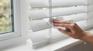 Close-up detail of easy-clean PVC faux wood venetian blind slats being wiped down