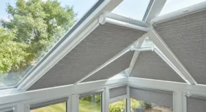 Close-up of thermal roller blinds mounted on conservatory roof glazing to reduce heat gain.