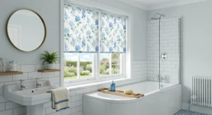 Moisture resistant blue floral roller blinds installed in a bright family bathroom.