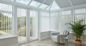 Cost-effective PVC vertical blinds fitted neatly inside conservatory window recesses for a clean, minimalist look.