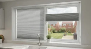 Made-to-measure grey honeycomb blinds fitted seamlessly on a modern kitchen window to reduce glare.