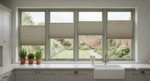 Custom-made pleated blinds fitted cleanly into a contemporary kitchen window overlooking a British garden.
