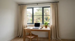 A modern matt black curtain pole for small windows framing a stylish home office view