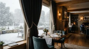 Snowy scene outside while thermal curtains for energy saving keep a dining room warm inside.
